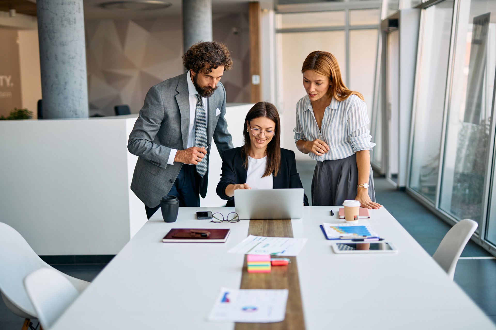 Business professionals collaborating at modern office meeting table